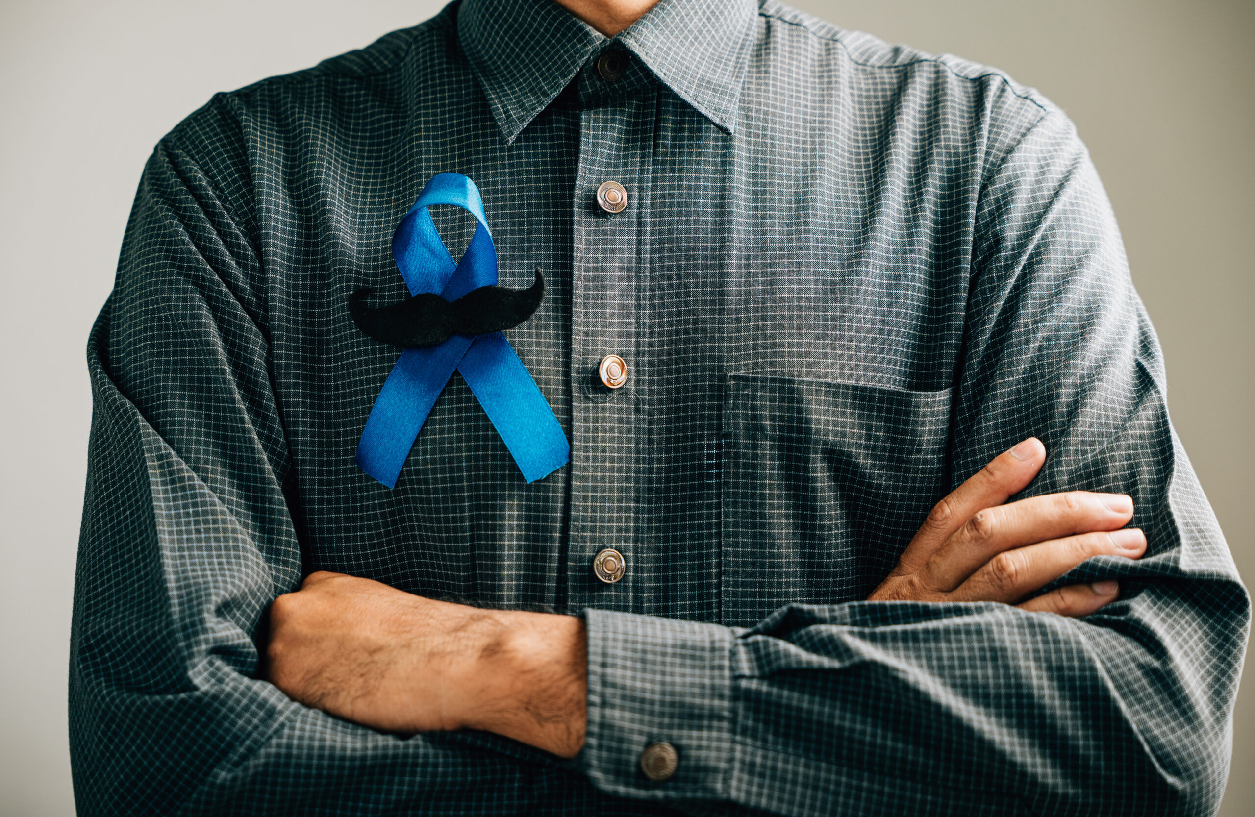 In support of vital causes, men's hands feature a Blue Ribbon with a moustache, signifying awareness for Colon cancer, Colorectal cancer, Child Abuse, world diabetes day, and International Men's Day.